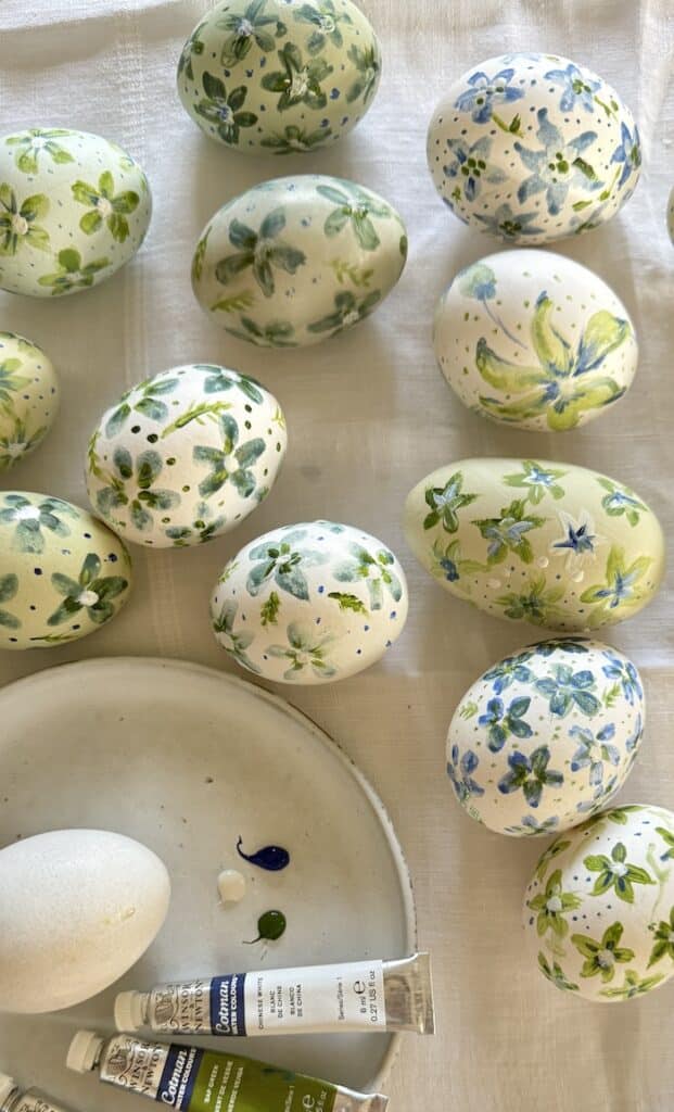 eggs painted with blue and green flowers for a table decor