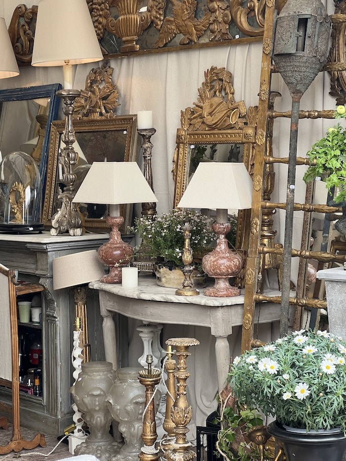 antique lamps and furniture at a brocante fair in france