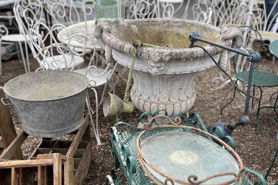 stone urns and antique garden furntiure at a french brocante