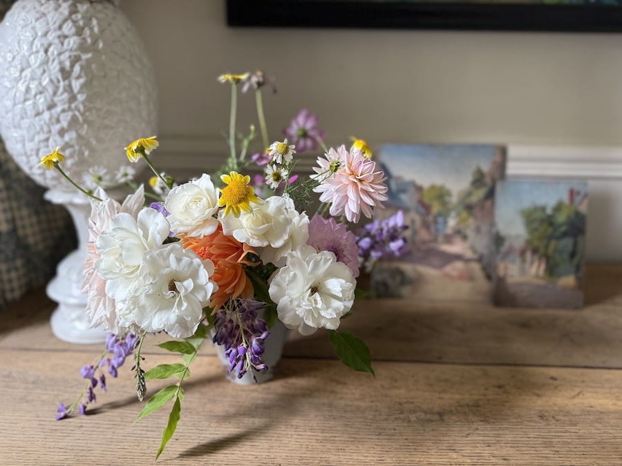 bouquet from the garden on chest of drawers with paintings